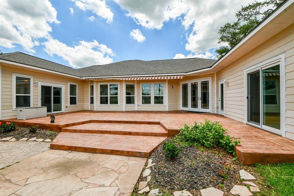 Notice the 3 entry points to the home. 2 of those go to bedrooms so you/guests can walk out in the mornings for a cup of coffee with an electric retractable covered awning.