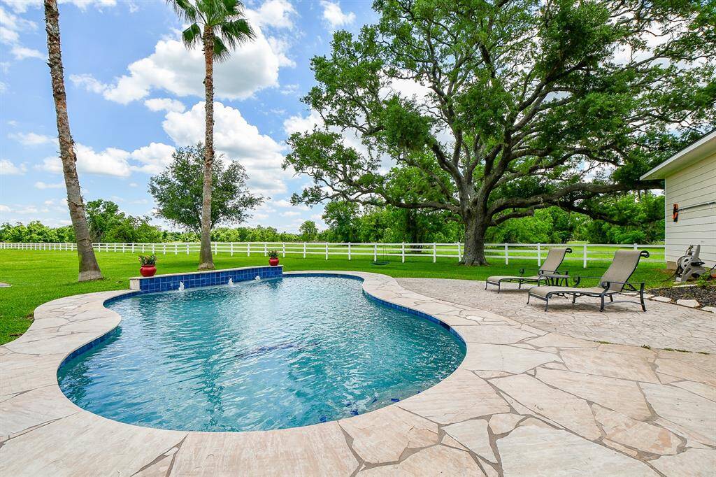 Oversized in ground pool with fountains