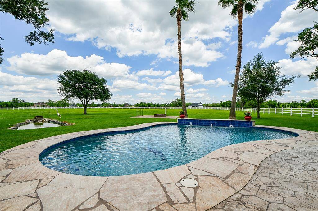 Fire pit in the back and another Khoi pond as well. Fully fenced backyard oasis.