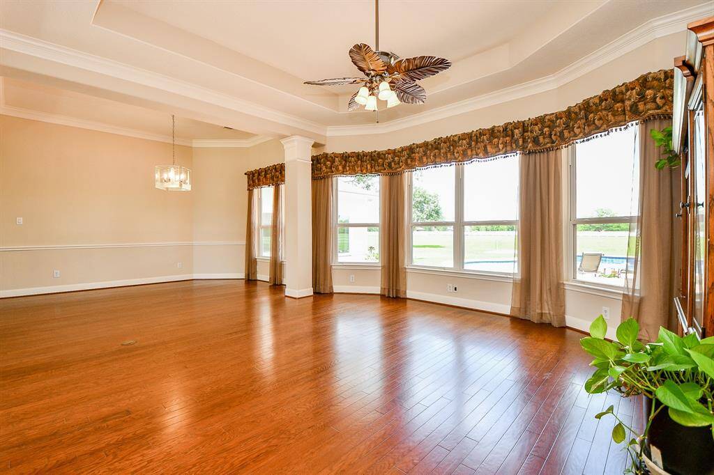Living room/dining room with gorgeous wood flooring, high ceilings, crown moulding and THAT VIEW!