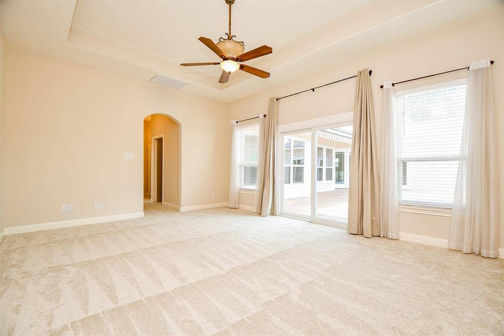 Primary bedroom is its own part of the house. Has a hallway connecting to the double closets and en suite bath.
