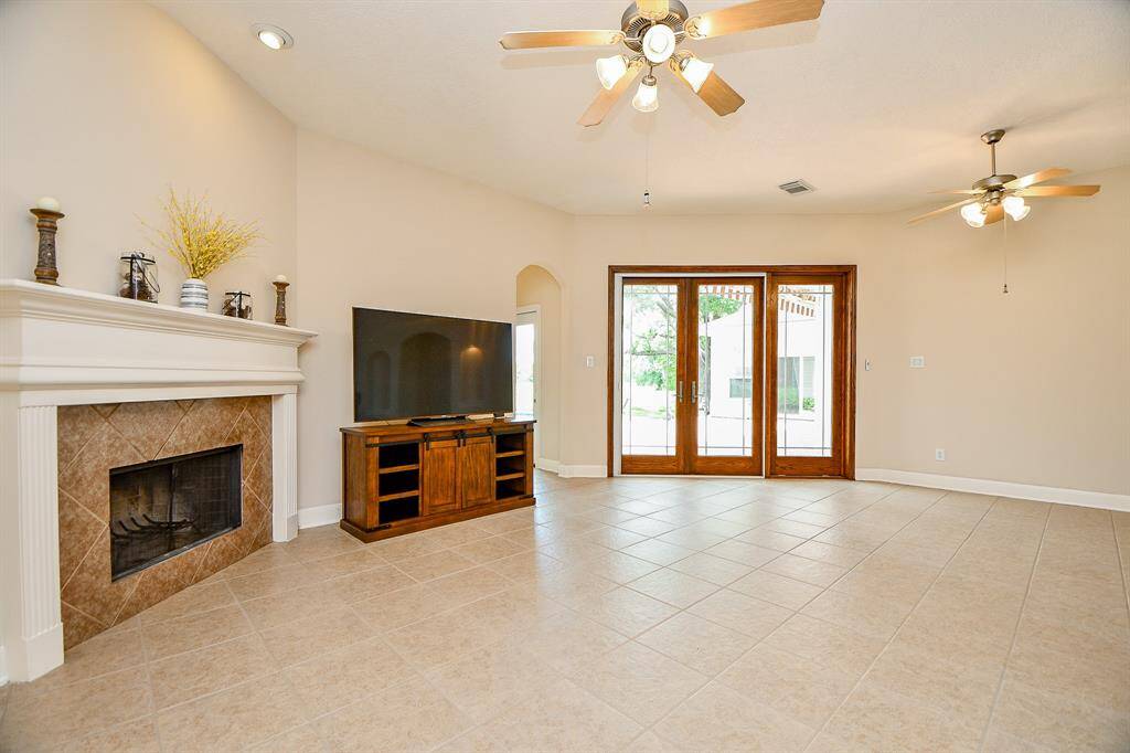 Family room with Fireplace and double French doors leading to your backyard oasis