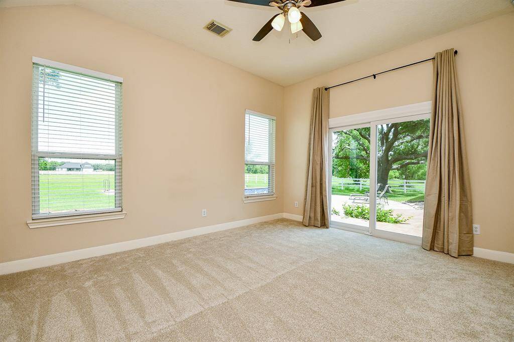 Third bedroom is a guest suite with sliding glass doors overlooking the pool and patio