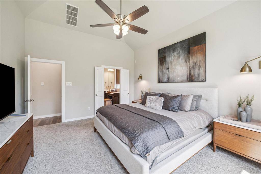 Primary bedroom off the back of the home has unobstructed views to the green belt and backyard.