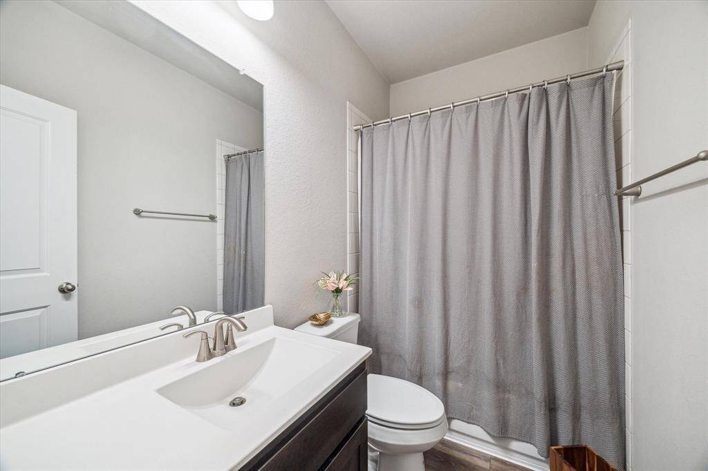 An additional full bath located between bedroom 3 and 4.