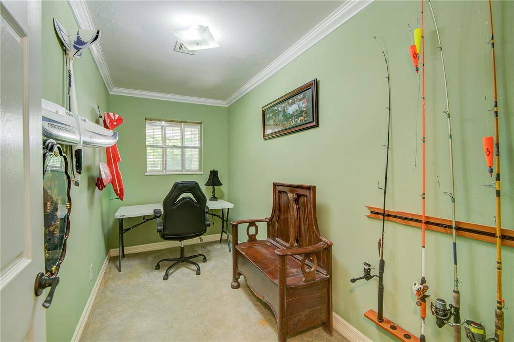This versatile flex space features crown molding and serene backyard views, making it an ideal spot for a home office, workout area, or creative studio.