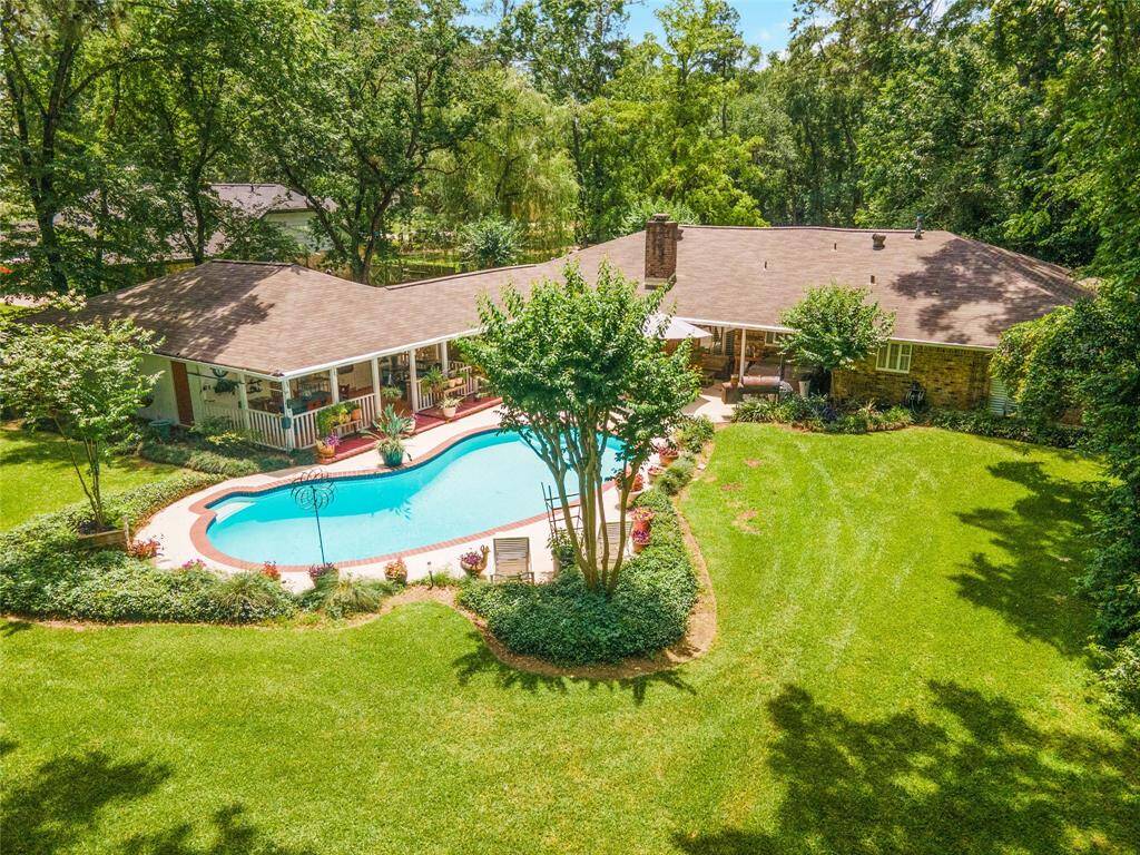 Imagine yourself entertaining poolside on this expansive lot, complete with mature landscaping and a spacious covered patio for year-round enjoyment.