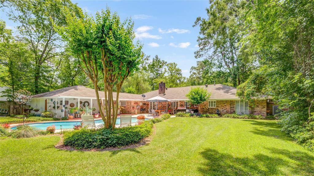 From this corner of the yard, take in a sweeping view toward the home, framed by lush landscaping and abundant green space for privacy and relaxation.