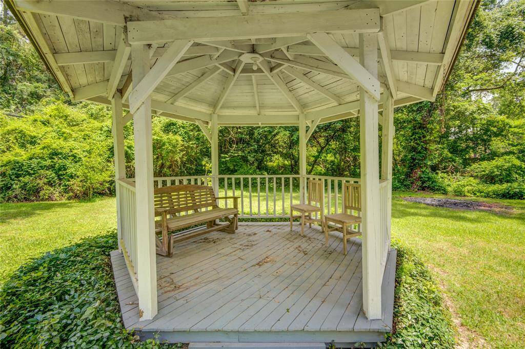 A close-up of the gazebo reveals its inviting design, nestled amid lush greenery for a peaceful outdoor retreat.
