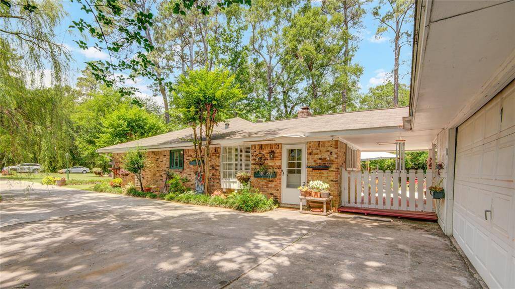 This view of the driveway side of the home reveals the private entrance to the mudroom and a window into the bright and welcoming breakfast area.
