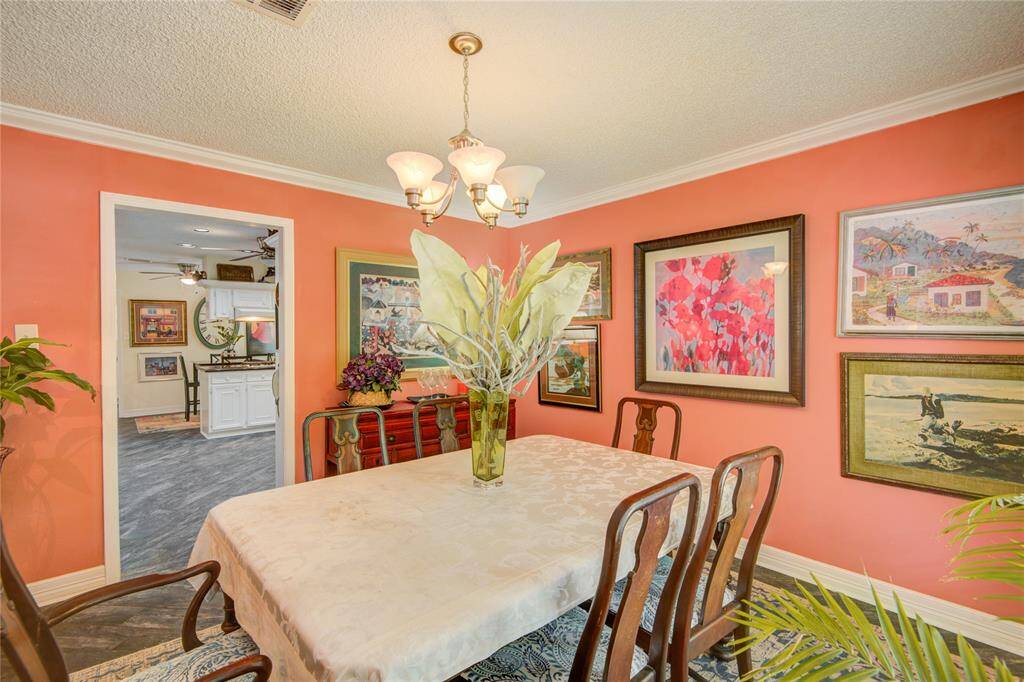 From this angle, the formal dining room opens up to reveal the bright kitchen and cozy breakfast area beyond, creating a seamless flow for everyday living and entertaining.