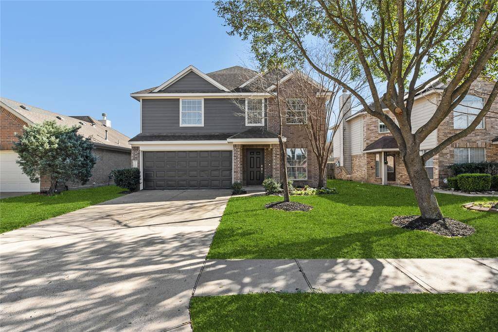 Exterior features fresh exterior paint and two car garage with covered patio.