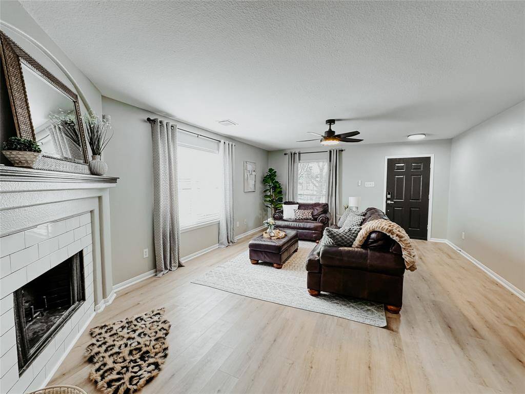 View of living room. Lots of natural lighting and luxury vinyl flooring throughout. Gas operated fireplace.