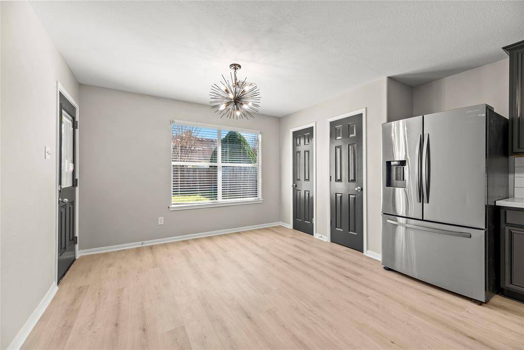 Kitchen with backdoor that leads to back patio.