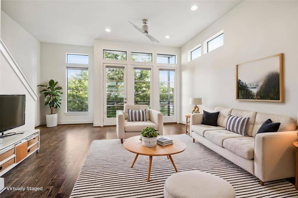 Bright and spacious living room.  French doors lead to a balcony.
