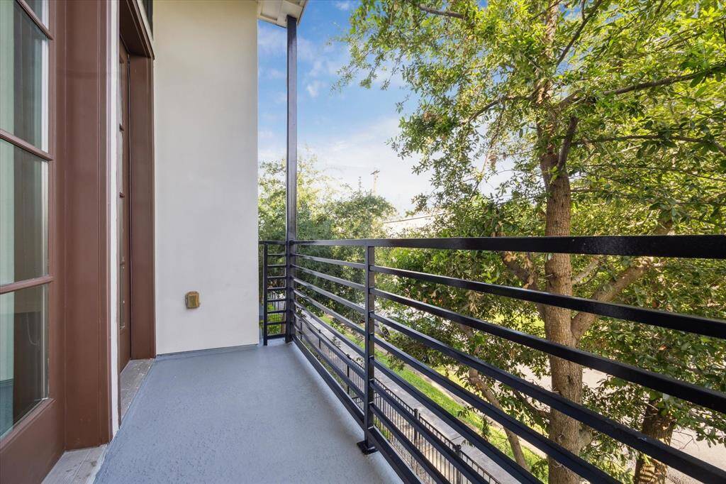 Sleek new waterproof balcony deck off of the living room, with metal railing.  Ideal for stepping outside for a quick breath of fresh air.