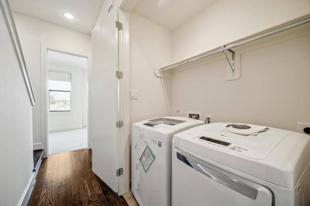 Laundry room on 3rd floor with a washer and dryer and a shelf above for storage.