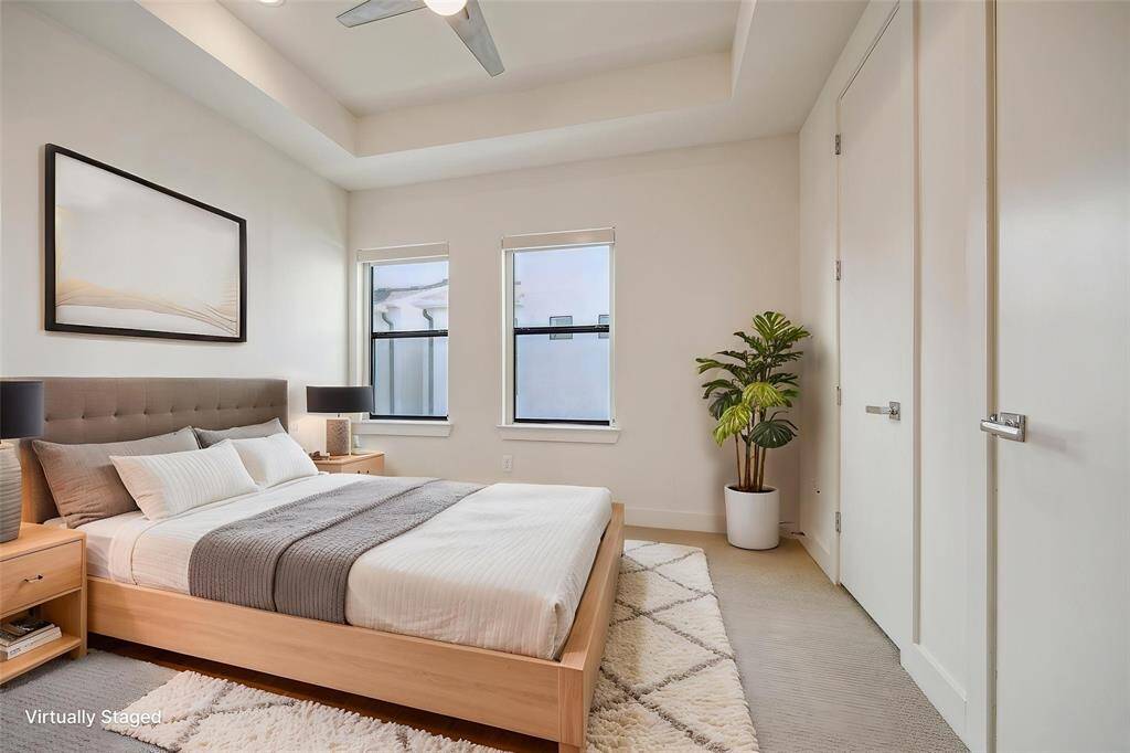 3rd floor bedroom down the hall from the primary bedroom.  Features 2 closets on the right and and 2 windows facing the back of the townhome.