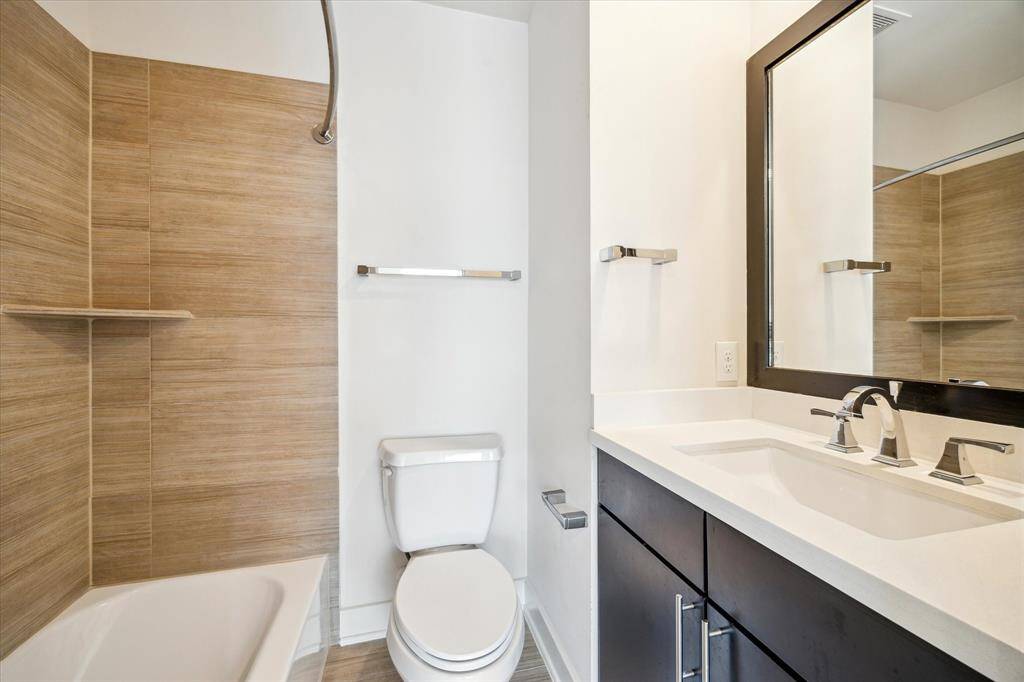 Ensuited bathroom connected to secondary bedroom on 3rd floor.  Features a tub shower combo and tile floor.