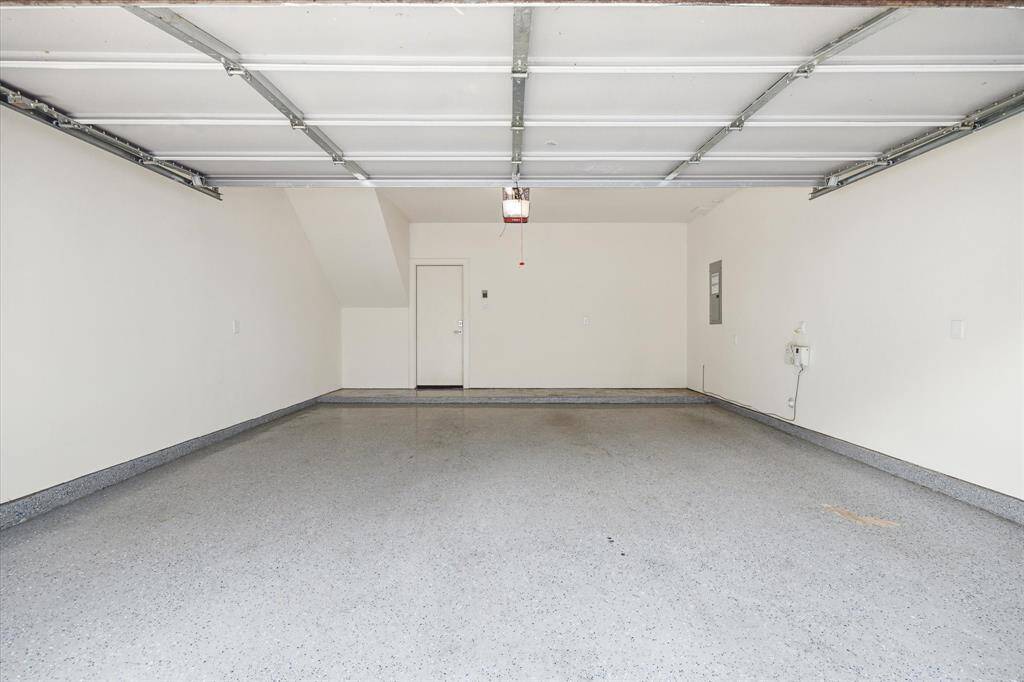 Spacious two-car garage with a durable, speckled epoxy floor.