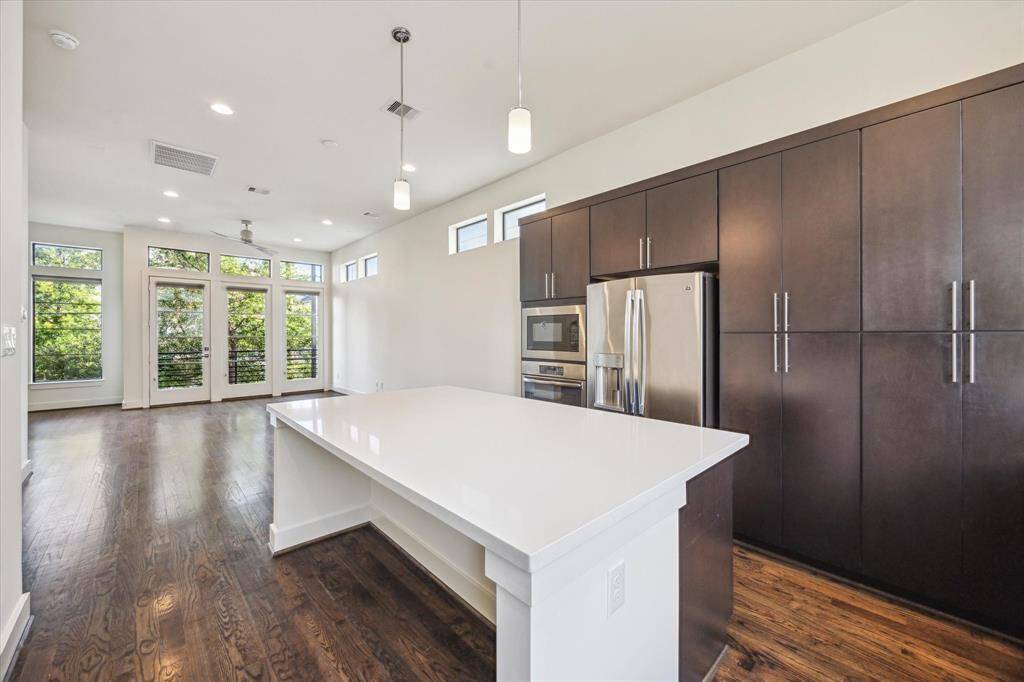 The kitchen is well-lit with pendant lights and natural light.  Breakfast bar seats 4 barstools comfortably.
