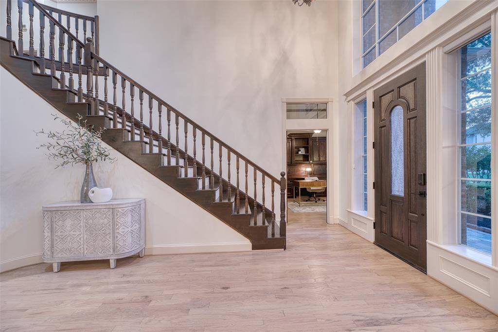 Abundant natural light pours in through oversized windows, highlighting the architectural lines and open design.
