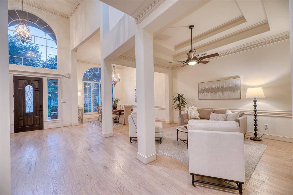 Sophisticated front room with soaring ceilings and large windows, perfect for welcoming guests or relaxing in style.