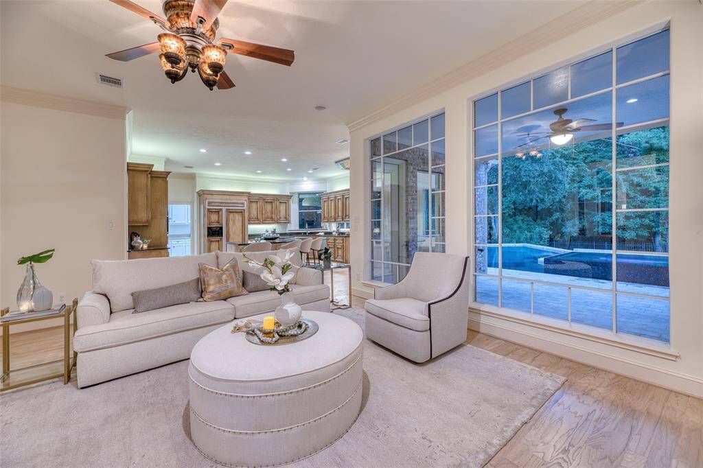 Open-concept living room with views of the pool and beautiful natural light.