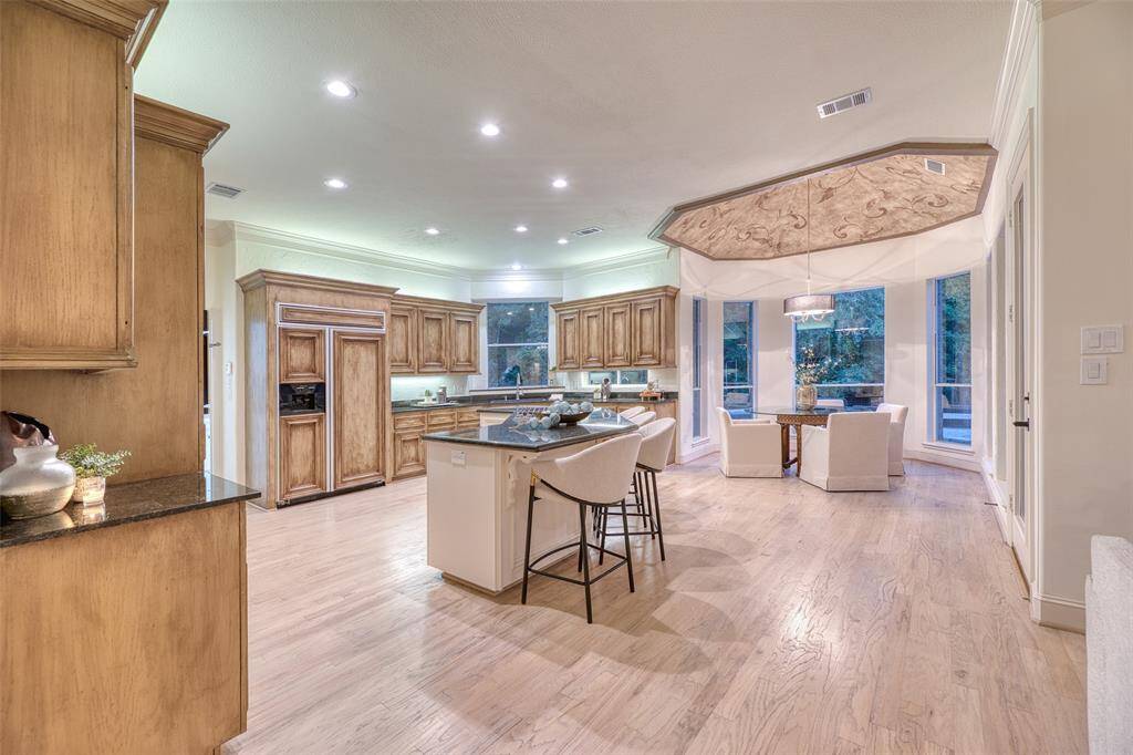 Spacious kitchen with high ceilings, recessed lighting, and a functional layout designed for cooking and gathering.