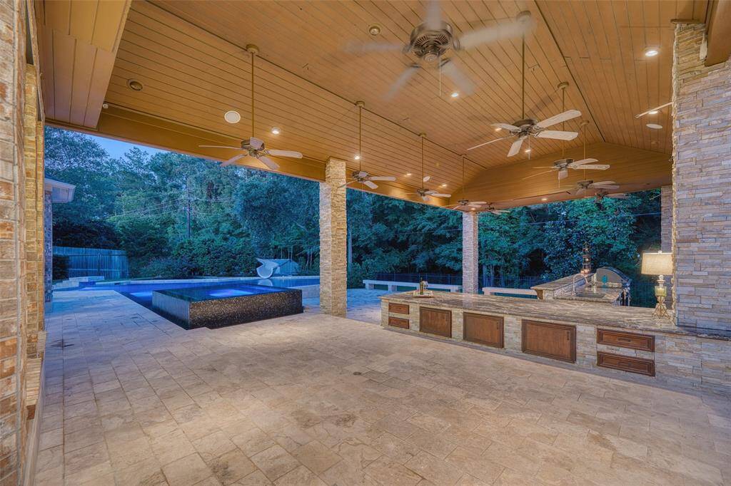Spacious covered patio area perfect for shaded seating, outdoor dining, or grilling.