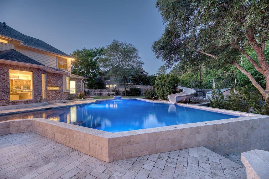 Entertainer’s Dream – Backyard layout combines swimming, seating, and scenery for the ultimate hosting space.