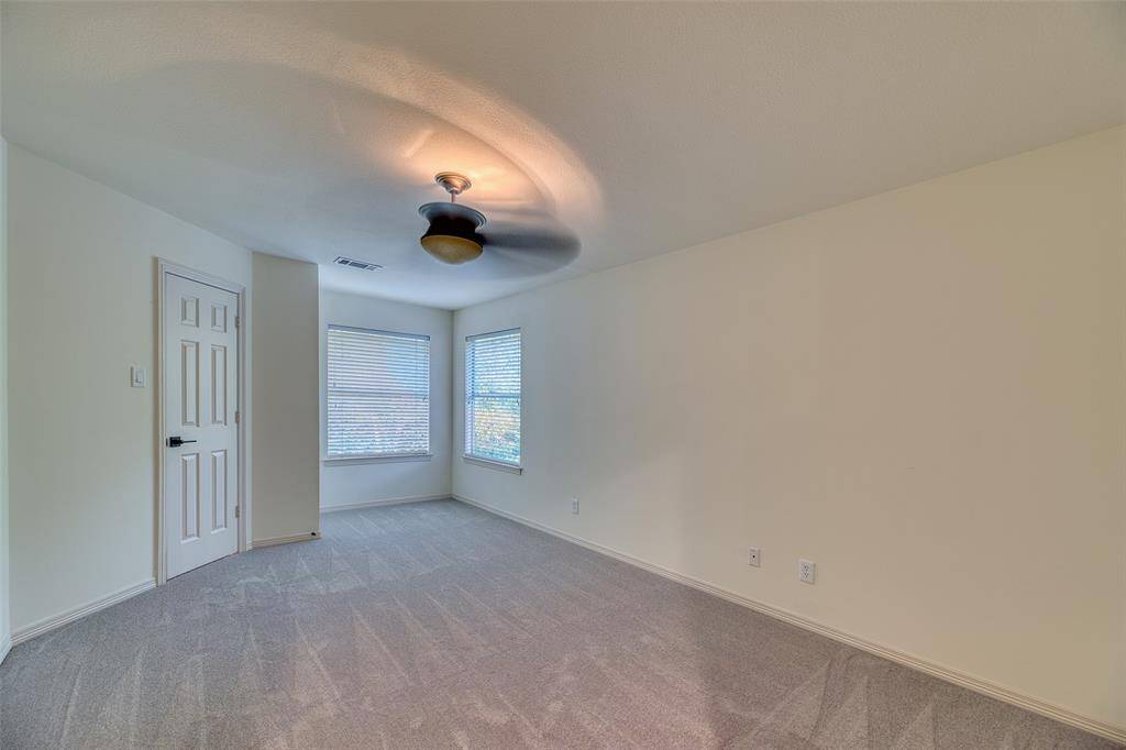 Generously sized bedroom with plush new carpet, ceiling fan, and large closet—perfect for guests or family.