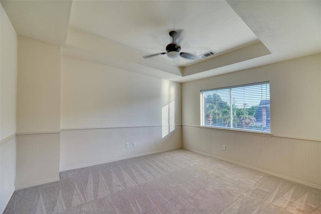 Generously sized bedroom with plush new carpet, ceiling fan, and large closet—perfect for guests or family.