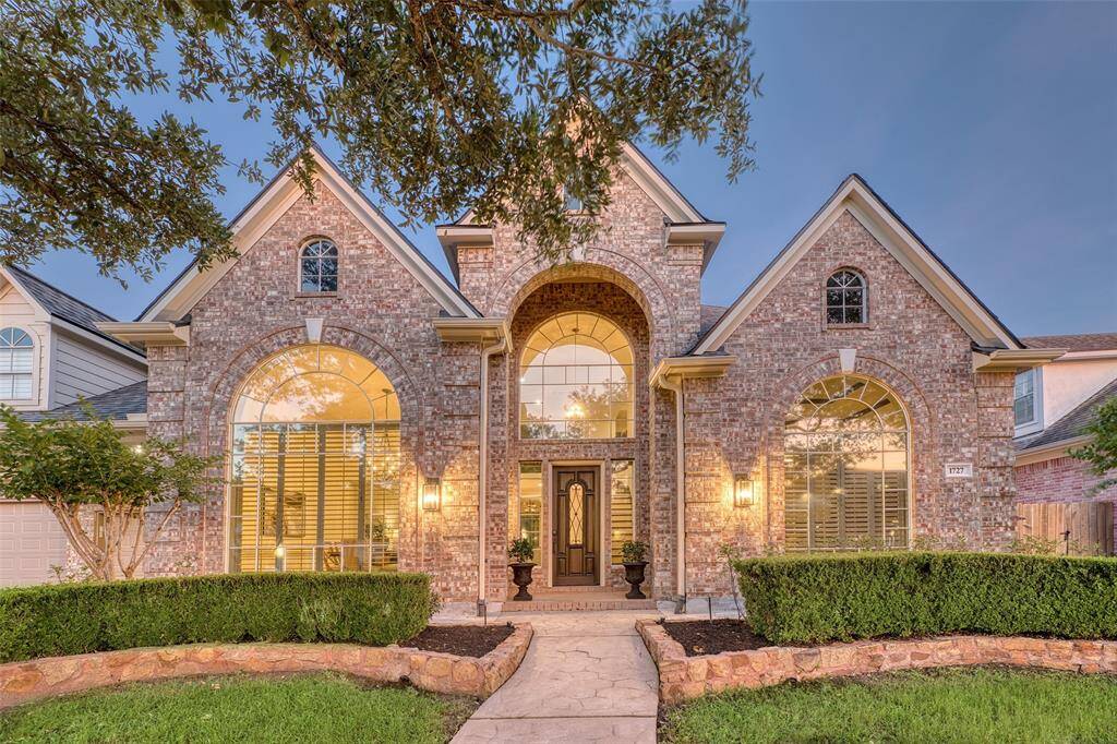 Welcoming covered entryway with detailed trim and an elegant front door.