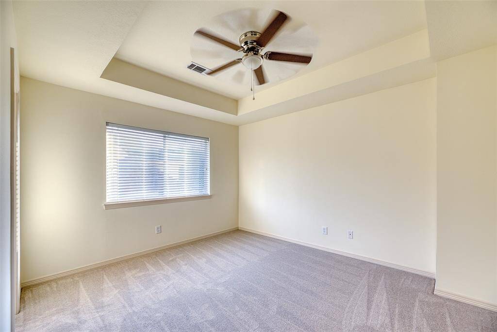 Generously sized bedroom with plush new carpet, ceiling fan, and large closet—perfect for guests or family.