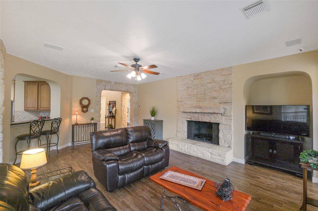 The family room offers warmth and style and features a stunning stone fireplace with an entertainment niche.