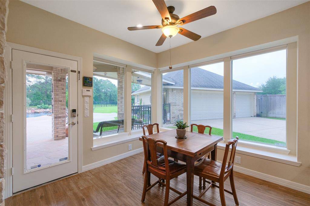 Enjoy a sunlit breakfast room with electric blinds and a ceiling fan for ultimate comfort.