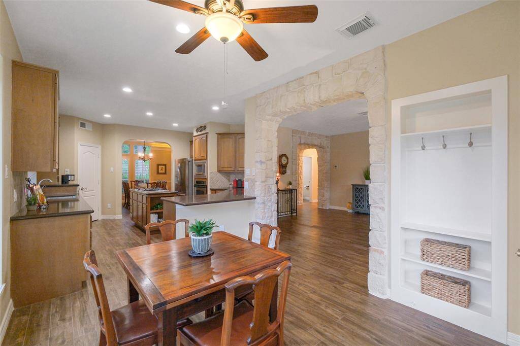 A stone archway adds rustic charm, and built-in shelving offers convenient storage.