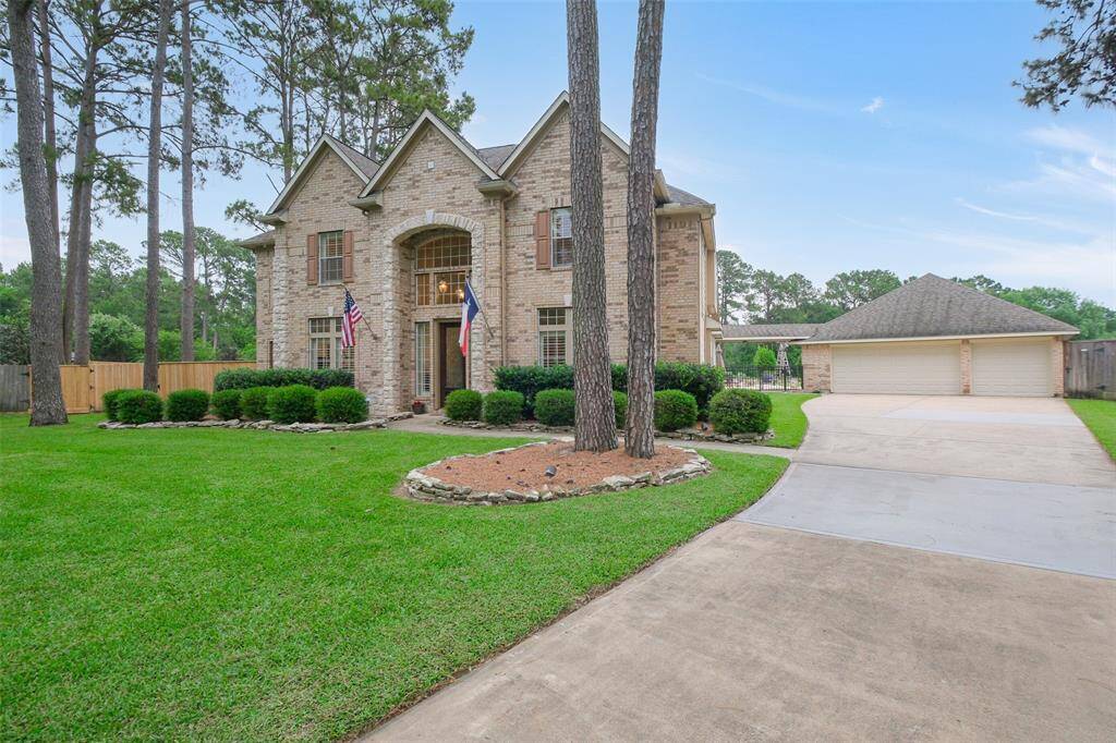 Expansive driveway leading to a spacious detached three-car garage. The home is equipped with 16 cameras with 3 inside the main living areas.