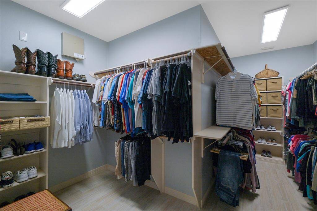 Expansive walk-in closet with recently added LED lighting.