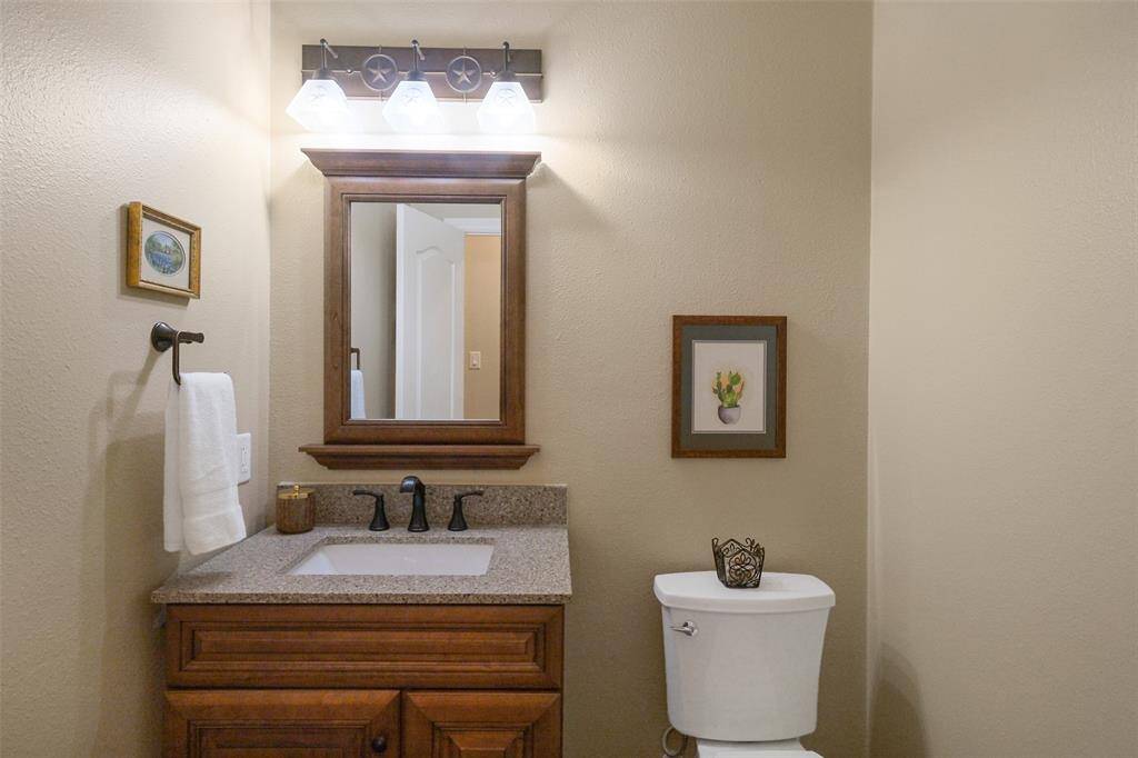 The first-floor powder room offers an updated vanity and recently replaced toilet.