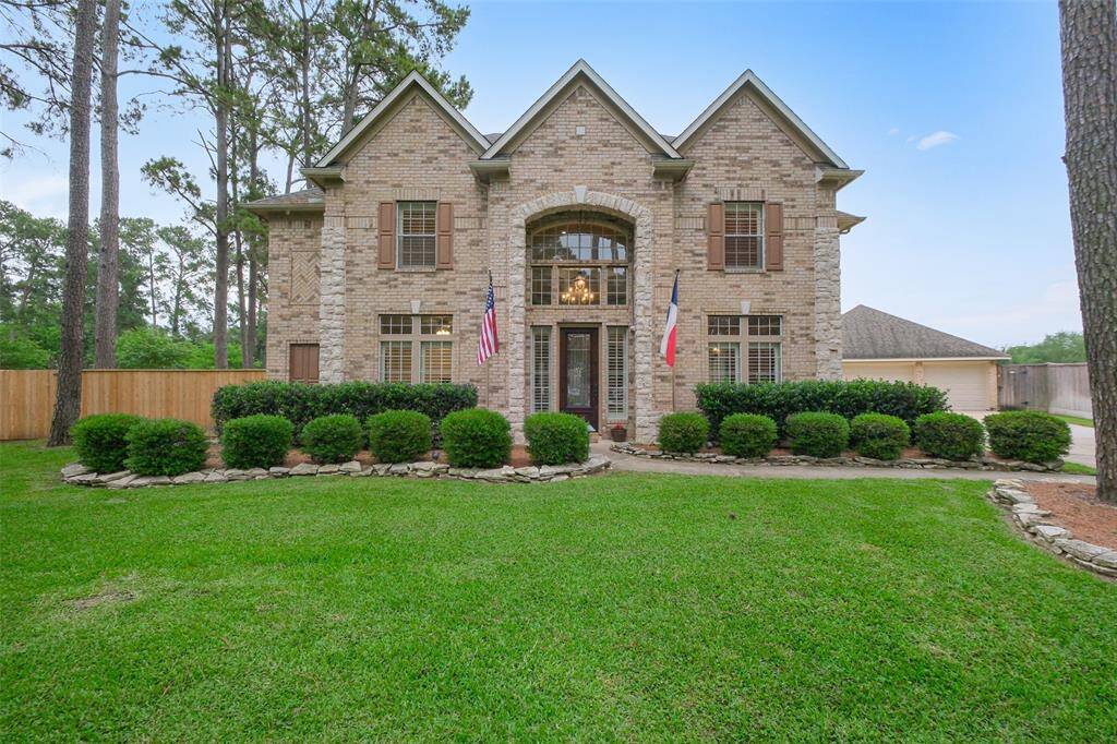 Impressive curb appeal with mature trees and lush landscaping, easily maintained by a full sprinkler system.