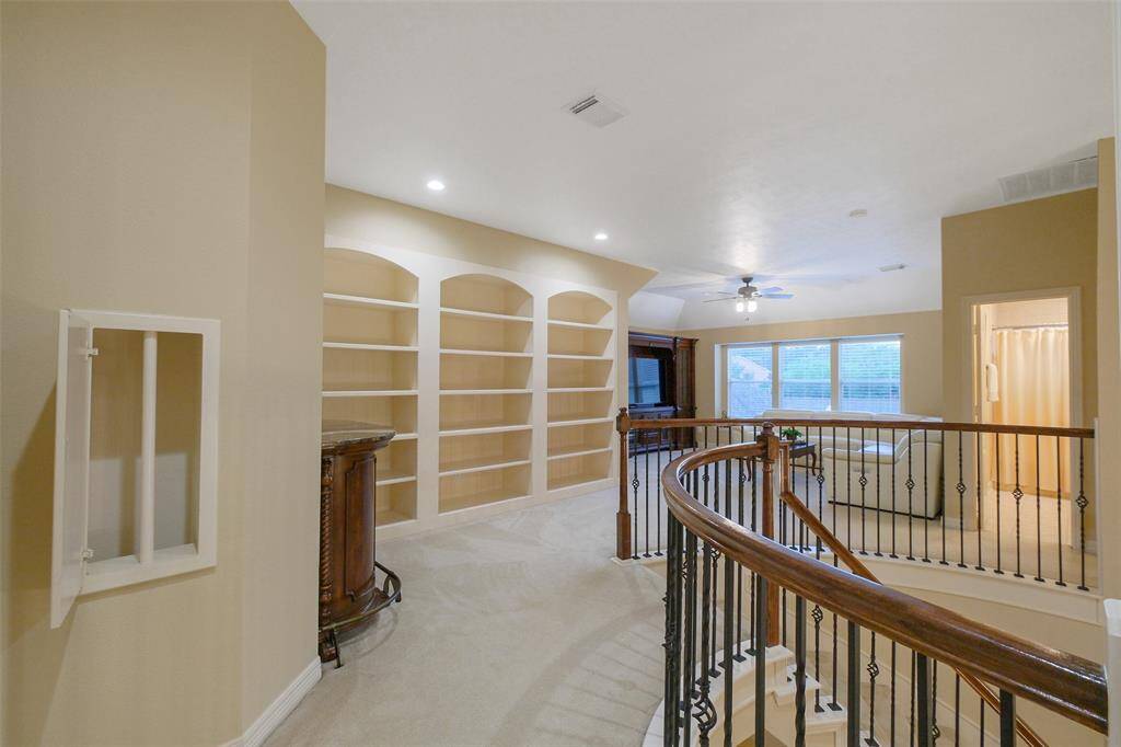 Upstairs features a convenient laundry chute and elegant built-in shelving, enhancing functionality and style.