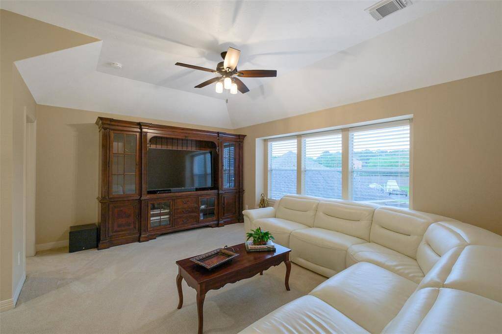 The game room includes a sectional and entertainment cabinet that can stay with the home.