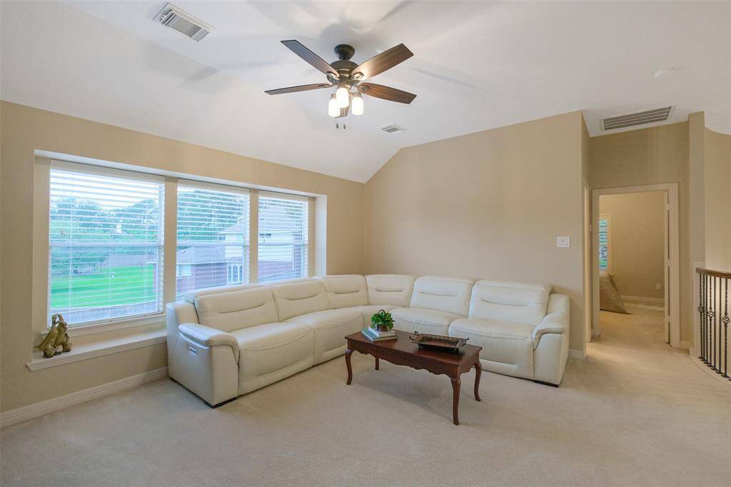 Spacious upstairs game room, perfect for entertaining.