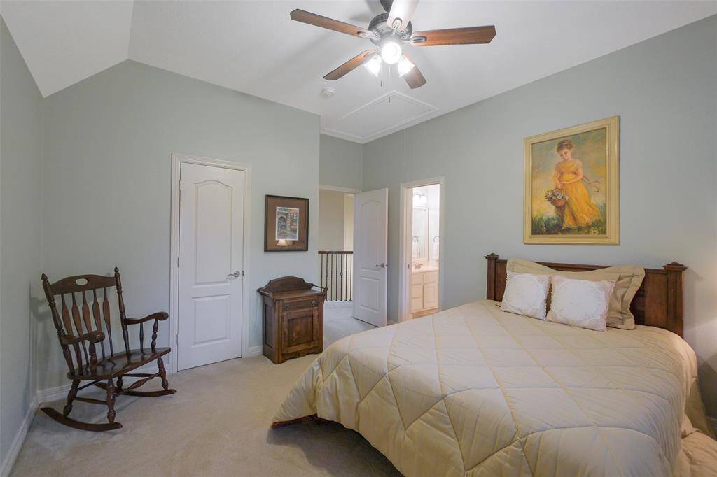 Bedroom 2 features a private vanity, shared shower with Bedroom 3, a walk-in closet, and a ceiling fan for comfort.