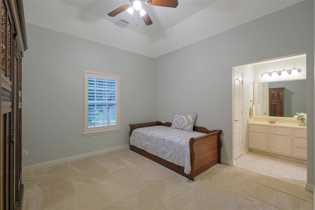 Bedroom 3 features a private vanity, shared shower with Bedroom 2, a walk-in closet, and a ceiling fan for comfort.