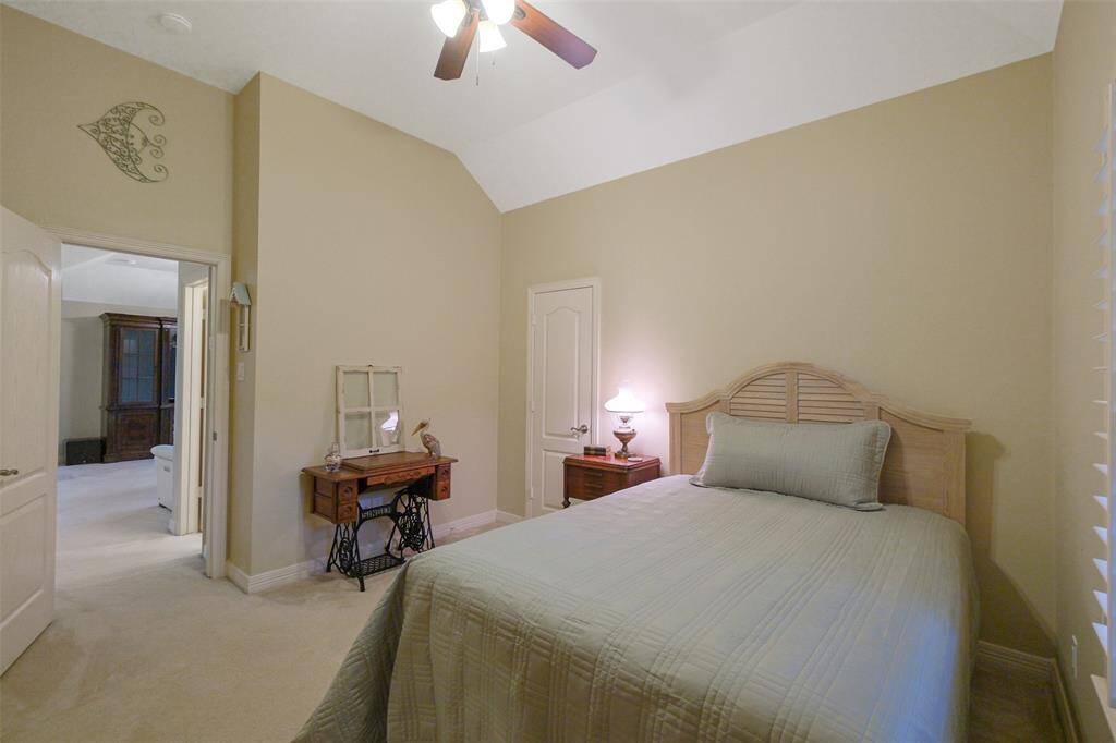 Bedroom 4, featuring a walk-in closet, ceiling fan, and convenient full bath just steps away.