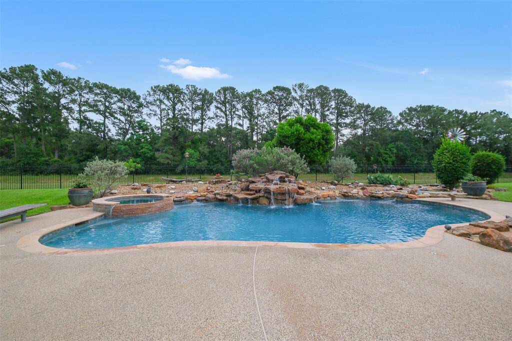 Enjoy the hot Texas summers in this fabulous pool with a rock waterfall and beautiful landscaping with lighting.
