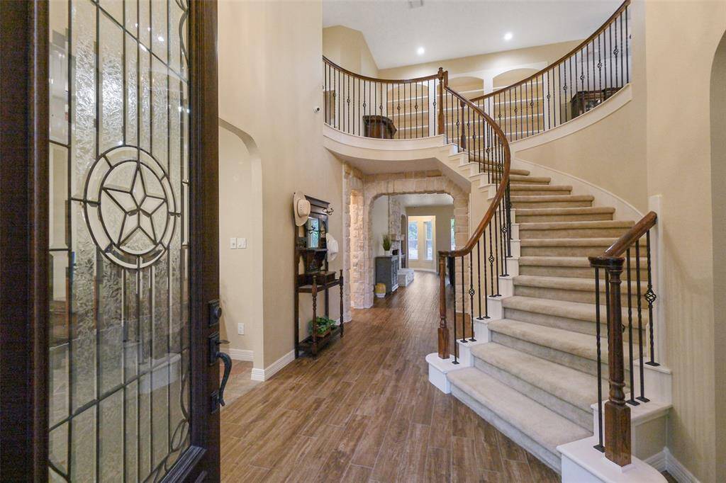 Elegant entrance featuring a stunning curved wrought iron staircase.